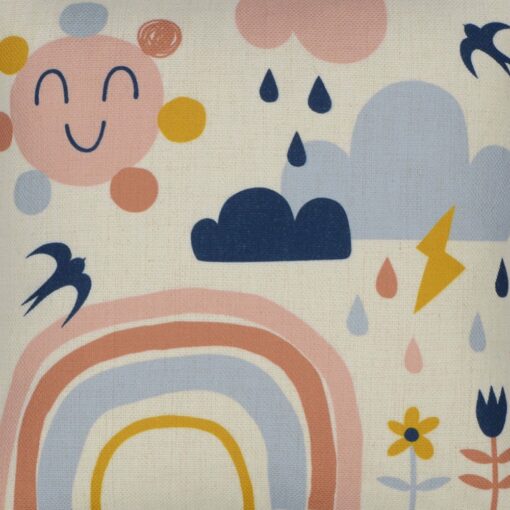 Close up photo of pastel coloured kids cushion cover with rainbow, sun, flowers and clouds