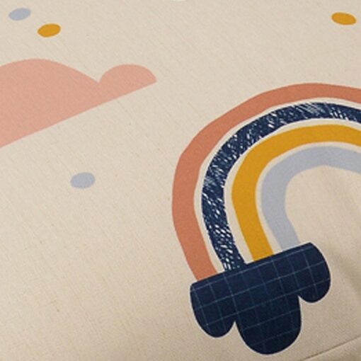 Close up image of large, colourful kids floor cushion cover with rainbows and pink clouds