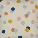 Close up photo of colourful kids cushion cover with pastel polka dots