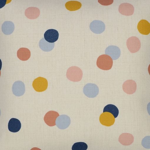 Close up photo of colourful kids cushion cover with pastel polka dots