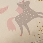 Close up photo of floor cushion cover with pink unicorns