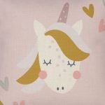 Close up photo of pink kids cushion cover with cute unicorn