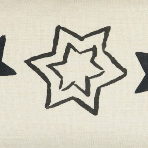 Close up photo of plain cotton linen cushion cover with three black stars