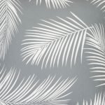 A close up view of repeating palm tree leaf print features on a waterproof grey outdoor cushion cover.