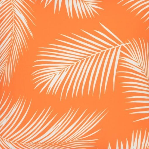 A close up view of a repeating palm tree leaf print features on a waterproof orange outdoor cushion cover.