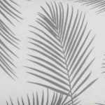 A close up of a rectangular grey outdoor cushion with beautiful palm leaf pattern on both sides.