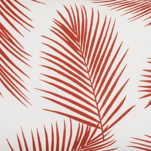 A close up view of a rectangular red outdoor cushion with beautiful palm leaf pattern on both sides.