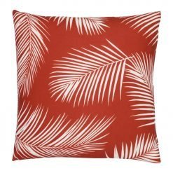 A repeating palm tree leaf print features on a waterproof red outdoor cushion cover.