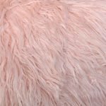 Close up image of a light pink rectangular fluffy faux fur cushion cover