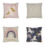 Image of a collection of four kids cushions including one pink unicorn cushion, one grey polka dot cushion, one rainbow cushion and a navy cushion with a unicorn design.