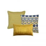 A picture of a yellow square cushion, a square blue and yellow patterned cushion and a single rectangular cushion in gold velvet.