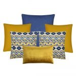 A collection of six cushion covers in blue and gold colours and patterns.