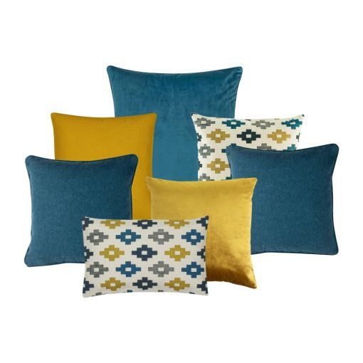 A collection of 7 cushions in blue and gold colours and patterns.