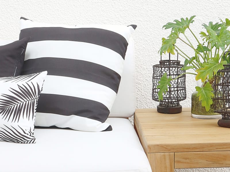 Black and white striped cushions on an outdoor sofa