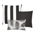 A set of three black and white outdoor cushion covers featuring striped, plain and botanical designs.