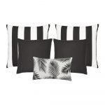 A collection of five black and white outdoor cushions featuring striped, plain and botanical designs.