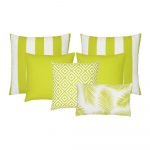 A collection of six lime green outdoor cushions featuring striped, plain, geometric and botanical designs.