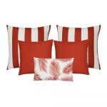 A collection of five red coloured outdoor cushions featuring striped, plain and botanical designs.