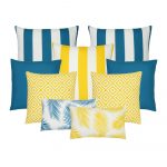 A set of nine outdoor cushion covers in teal and yellow cushion covers in striped, plain, geometric and leaf designs.