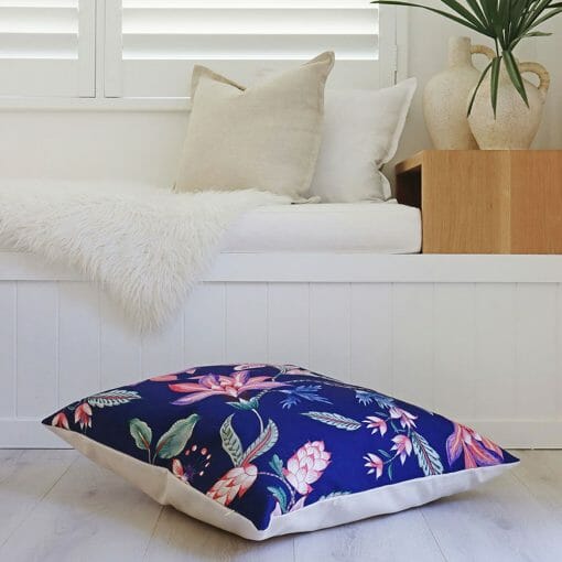 Photo of large, blue floor cushion with pink flowers