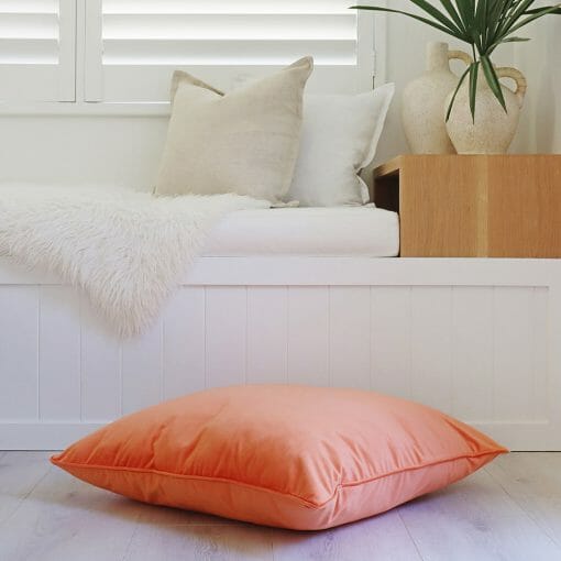 Orange-coloured velvet floor cushion level