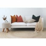 Linen cushions in autumnal colours on a white sofa with a cream throw