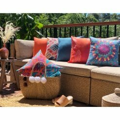 Bright orange and teal outdoor cushions in neutral brown sofa
