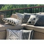 Tribal pattern black and white outdoor cushions in light brown sofa