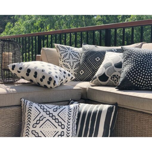 Tribal pattern black and white outdoor cushions in light brown sofa