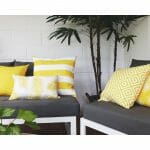 Bright yellow floral, striped and flora outdoor cushion covers in grey sofa