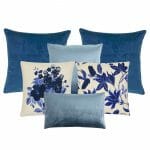 A set of blue cushions in velvet and polyester fabric with flower prints in china blue colour
