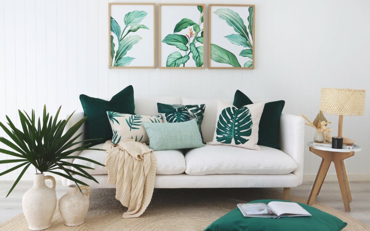 Leaf cushions arranged on a white sofa in a tropical styled room
