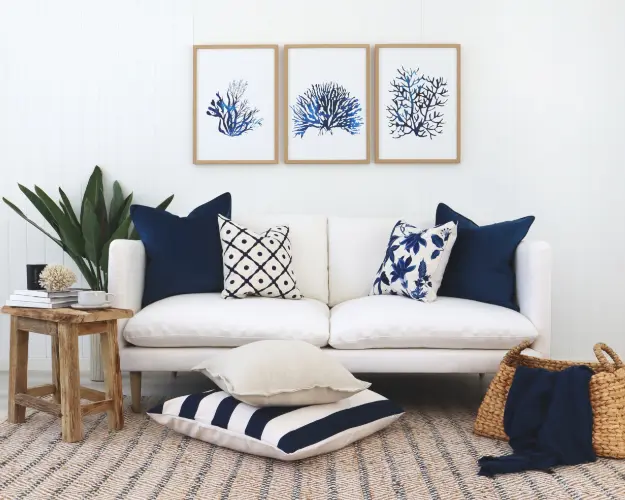 A set of matching lounge cushions arranged in a Hamptons style living room.