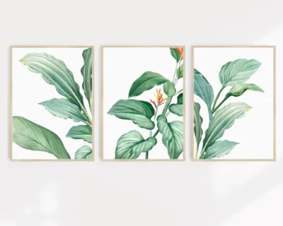 A set of three tropical wall art prints on a wall.