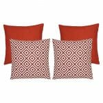 A collection of five red coloured outdoor cushions featuring two plain cushions and two geometric design cushions.