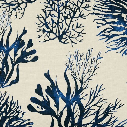 Close up of Hamptons blue and white cushion with coral print