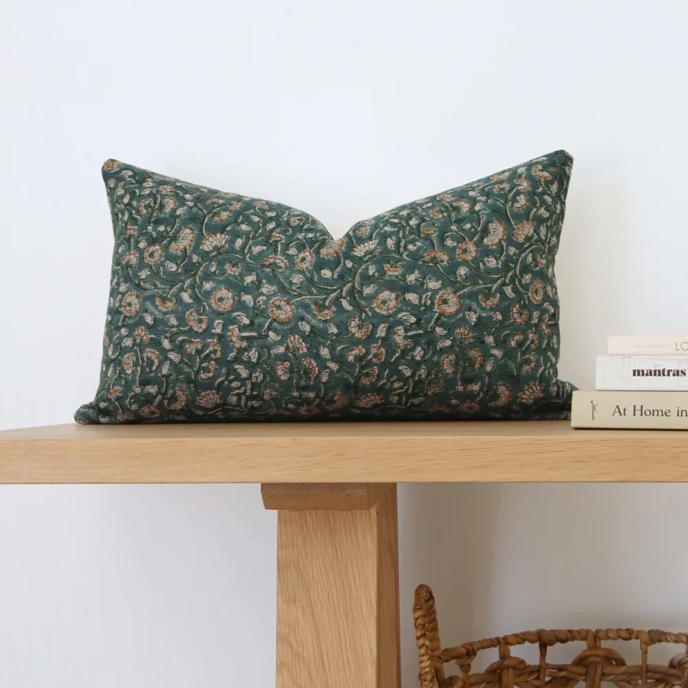A 30x50 cushion cover on top of a wood bench seat.