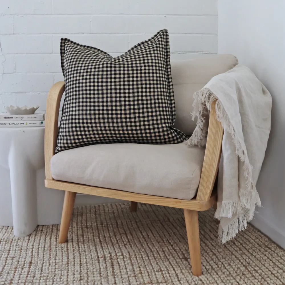 A 55x55 cushion cover sits to the side on a light coloured armchair.