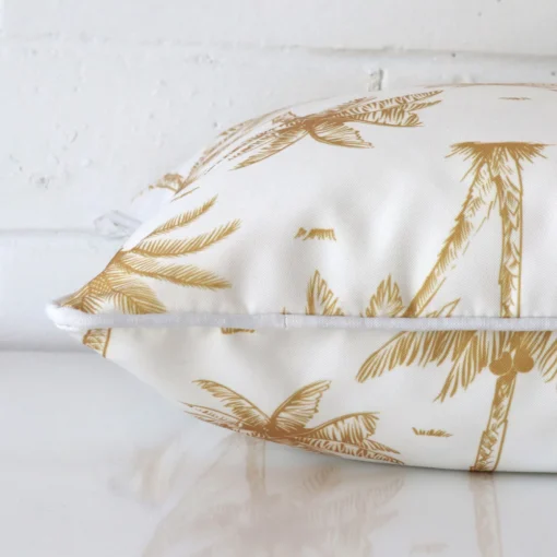 Mustard palm tree cushion cover laid on its back side. The image shows a side-on view of the outdoor material and its square dimensions.