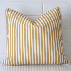 Gorgeous square outdoor cushion cover that has a mustard hue. It has a graceful striped design.