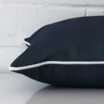 Close side shot of this navy blue outdoor cushion cover. The viewpoint shows how the rectangle design.