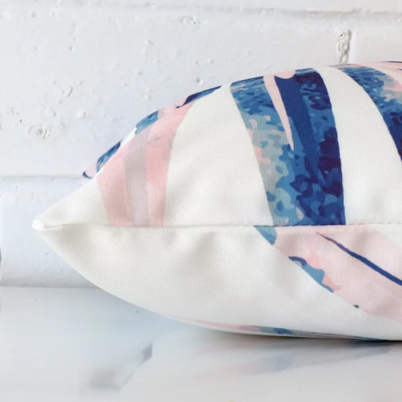 Lateral view of front and back panels of this outdoor cushion cover in a rectangle size and with pink colouring.