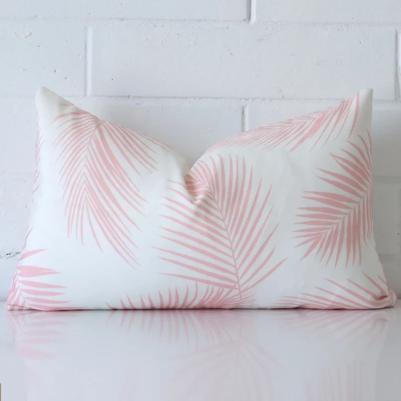 Byron Palm Waterproof Pink Outdoor Cushion Cover - Rectangle - SC938-30 Pink cushion cover in front of a white wall. It has a rectangle size and is made from a outdoor material.