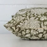 Lateral viewpoint of this linen square cushion. The floral design and olive green colour is shown from the side showing the front and rear panels.
