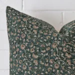 The corner of this designer square cushion cover is shown close up. The floral design is shown in greater detail.