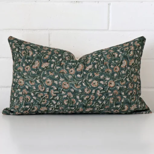 Designer cushion cover in front of a white wall. It has a rectangle size and is made from a designer material.