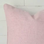 Magnified view of this linen pink cushion cover’s corner. It has a square size.