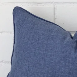 Macro shot showing the top left side of this rectangle linen cushion. The blue hue is magnified.