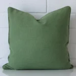 A premium linen sage green cushion in a square size.