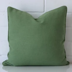 A premium linen sage green cushion in a square size.